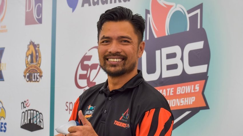 Bowls Asia Tigers player giving a thumbs up in front of the sponsor wall during Ultimate Week April 2022